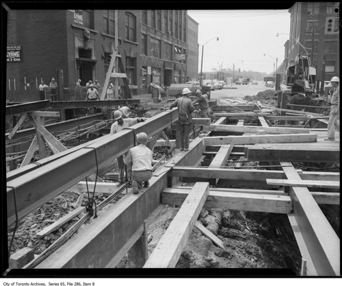 File consists of images of University Avenue being excavated for to build the subway. There are also some images of the avenue before excavation.